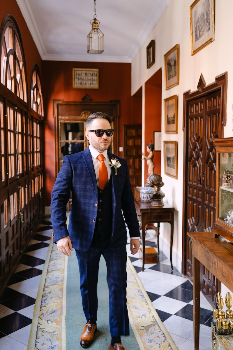 groom walking inside seville palace wedding venue spain. Intimate and romantic destination wedding in Seville.