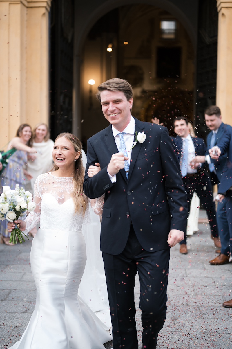 Bride and groom leaving church during intimate religious destination wedding in Seville Spain