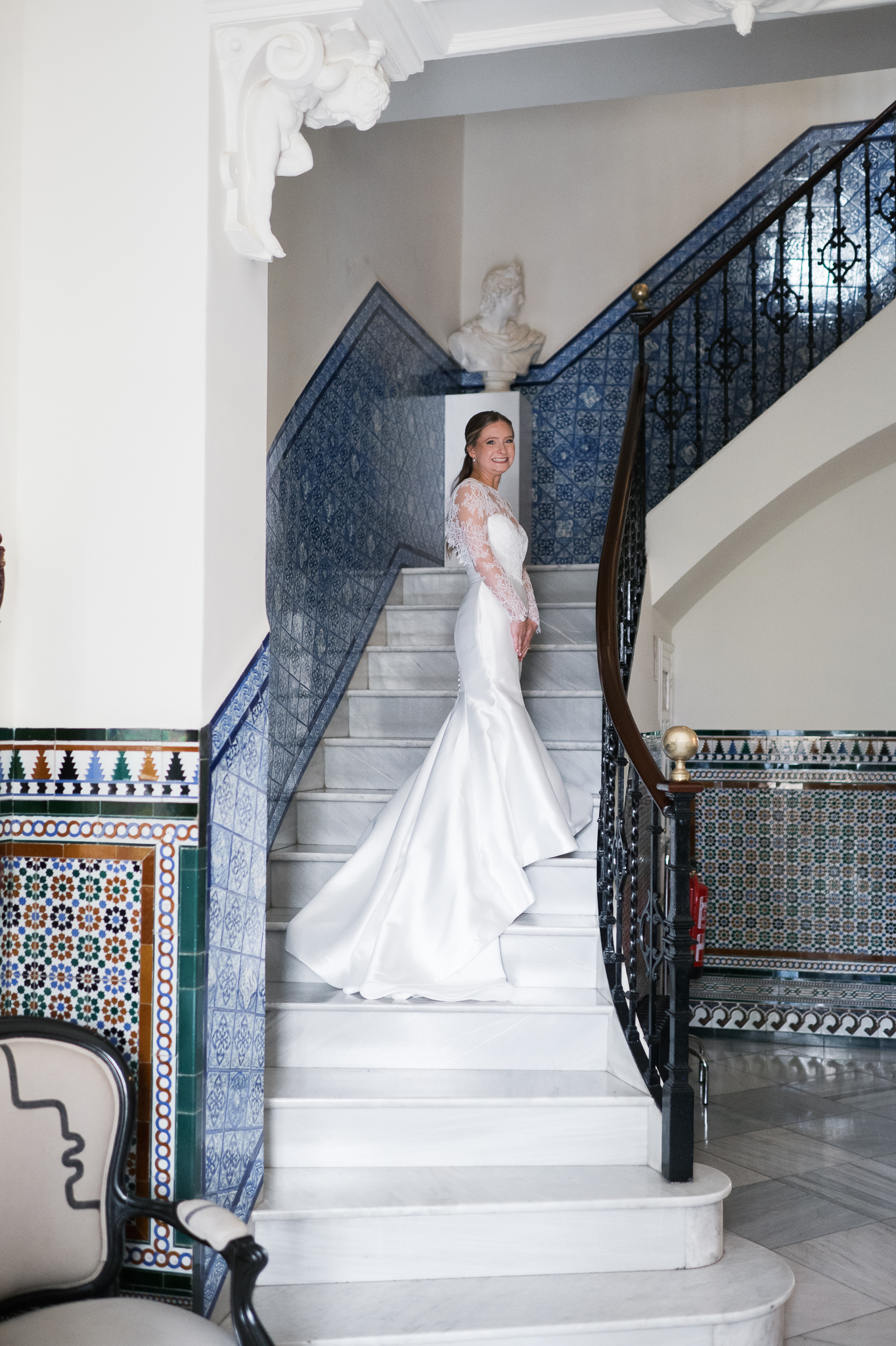 American bride portrait on a historic staircase during an intimate destination wedding in Seville Spain